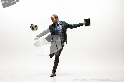 Image of Businessman with football ball in office