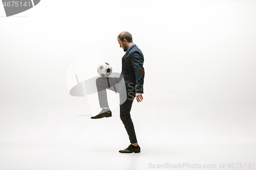 Image of Businessman with football ball in office