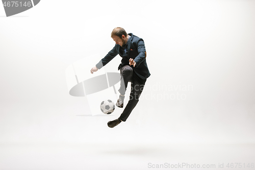 Image of Businessman with football ball in office