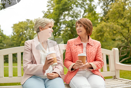 Image of senior women or friends drinking coffee at park