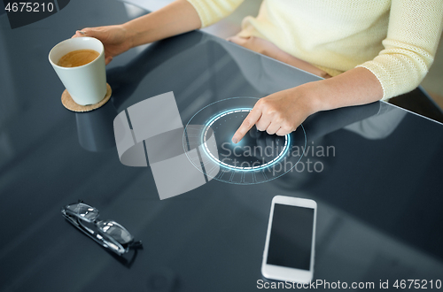 Image of woman with coffee using interactive panel