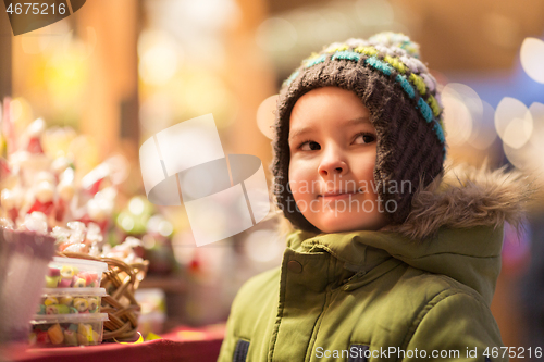 Image of happy little boy at christmas market shop