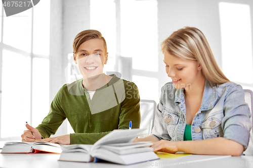 Image of high school students with books and notebooks