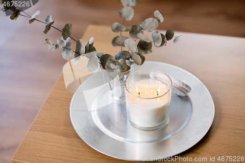 Image of burning white candles on table at cozy home