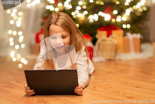 Image of smiling girl with tablet pc at christmas home