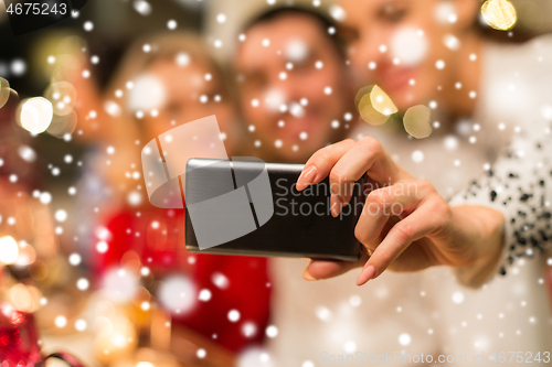 Image of close up of friends taking selfie on christmas