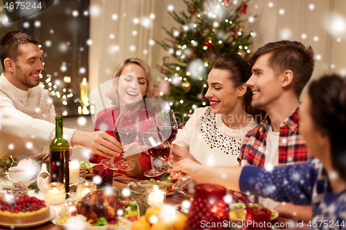 Image of friends celebrating christmas and drinking wine