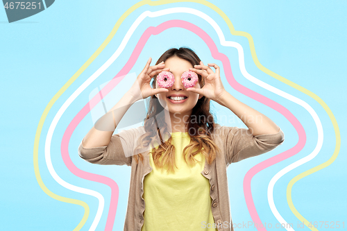 Image of happy asian woman with eyes of donuts