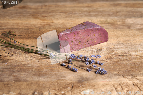 Image of Lavender cheese with bunch of fresh lavender flowers on rough wooden planks