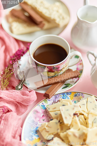 Image of Delicious dessert on pink background. Hot coffee or dark chocolate with white chocolate