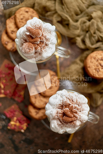 Image of Sweet dessert served. Hot chocolate with whipped cream on top and cookies