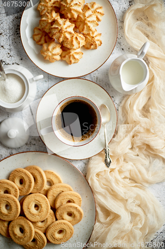 Image of Sweet dessert concept. Golden crunchy cookies served with cup of black coffee