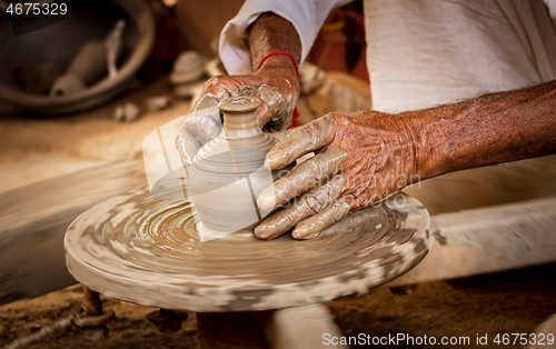 Image of Potter at work makes ceramic dishes. India, Rajasthan.