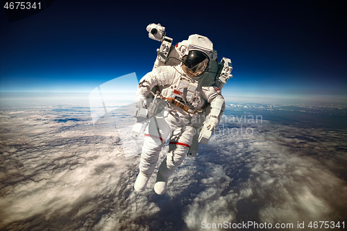 Image of Astronaut in outer space against the backdrop of the planet eart