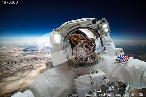 Image of Astronaut in outer space against the backdrop of the planet eart