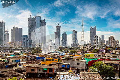 Image of Views of slums on the shores of mumbai, India against the backdr