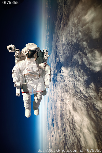 Image of Astronaut in outer space against the backdrop of the planet eart