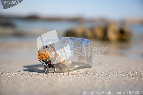 Image of Message in the bottle against the Sun setting down