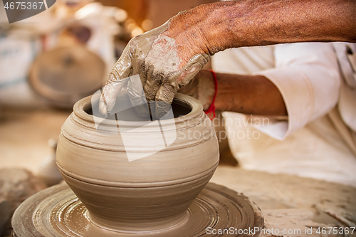 Image of Potter at work makes ceramic dishes. India, Rajasthan.