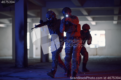Image of Soldiers squad in tactical formation having action urban environment