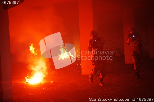 Image of military troops in action urban environment