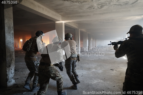 Image of military troops in action urban environment