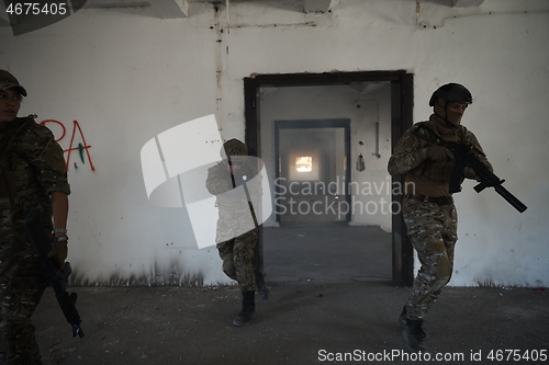 Image of military troops in action urban environment