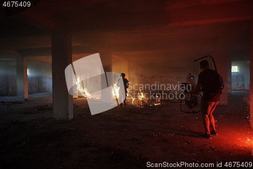 Image of Videographer Taking Action Shoot of Soldiers in Action urban environment