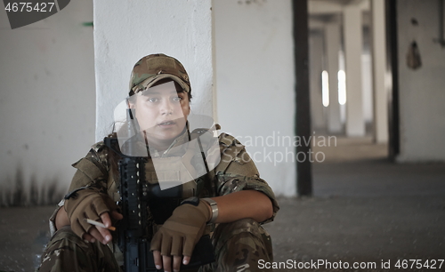 Image of military female soldier having a break