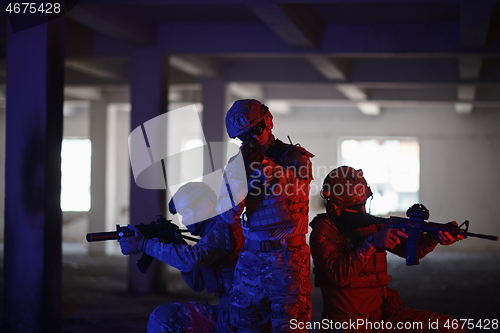 Image of Soldiers squad in tactical formation having action urban environment