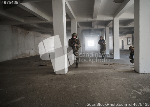 Image of military troops in action urban environment