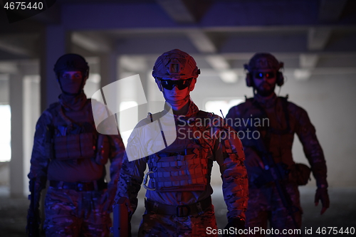 Image of soldier squad team portrait in urban environment colored lightis