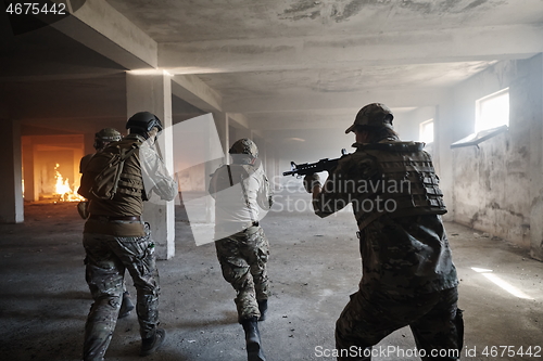 Image of military troops in action urban environment