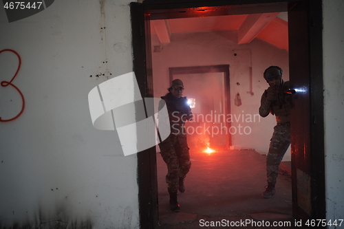 Image of military troops in action urban environment