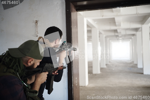 Image of military troops in action urban environment