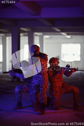 Image of Soldiers squad in tactical formation having action urban environment