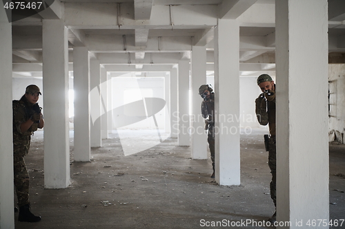 Image of military troops in action urban environment