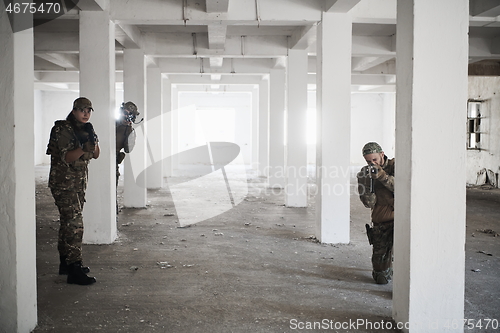 Image of military troops in action urban environment