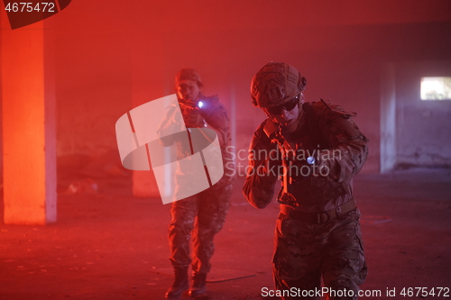 Image of military troops in action urban environment