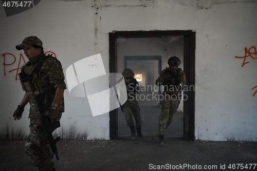 Image of military troops in action urban environment