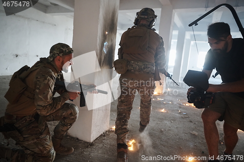 Image of Videographer Taking Action Shoot of Soldiers in Action urban environment