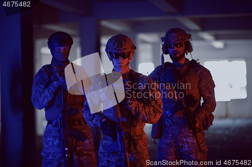 Image of soldier squad team portrait in urban environment colored lightis