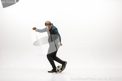 Image of Businessman with football ball in office