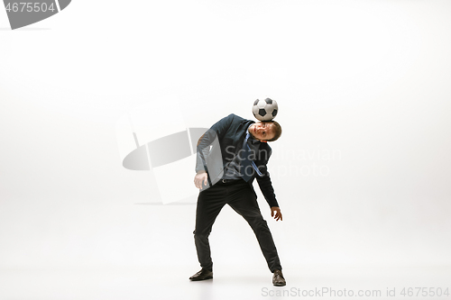 Image of Businessman with football ball in office