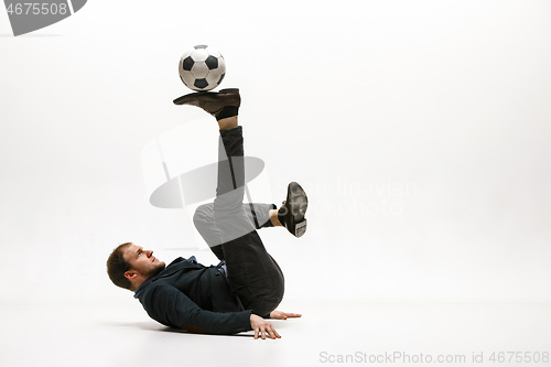 Image of Businessman with football ball in office