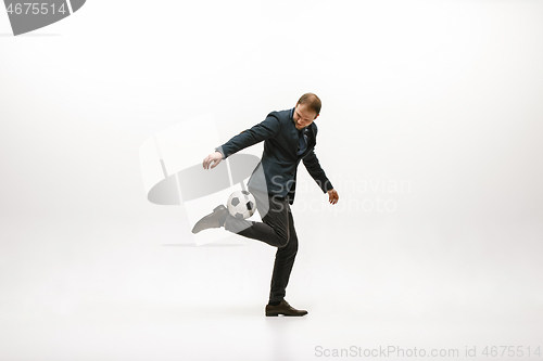 Image of Businessman with football ball in office