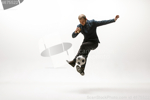 Image of Businessman with football ball in office