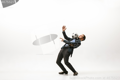 Image of Businessman with football ball in office