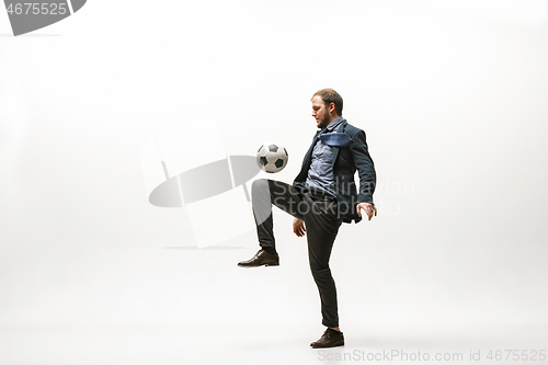 Image of Businessman with football ball in office