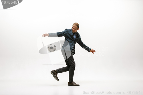 Image of Businessman with football ball in office